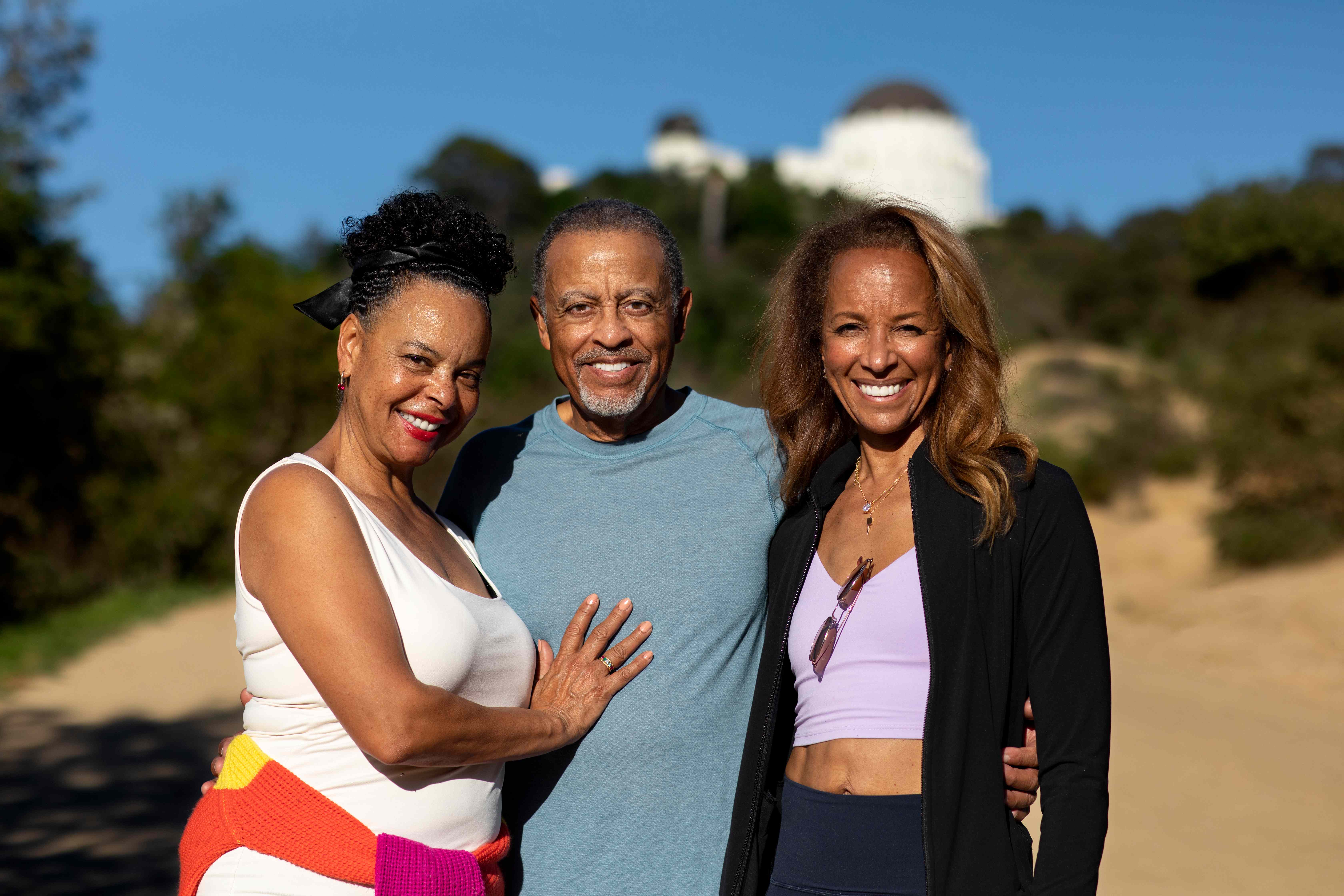 Three seniors smiling together outdoors